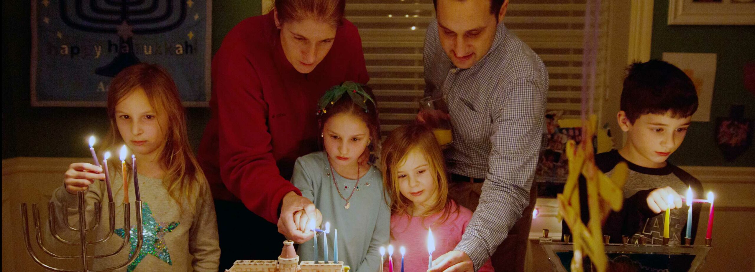 PTJL-family lighting chanukah candles