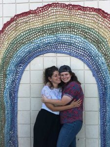 two women under a rainbow