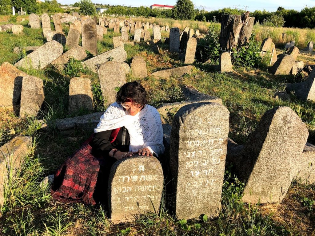 woman by gravestone