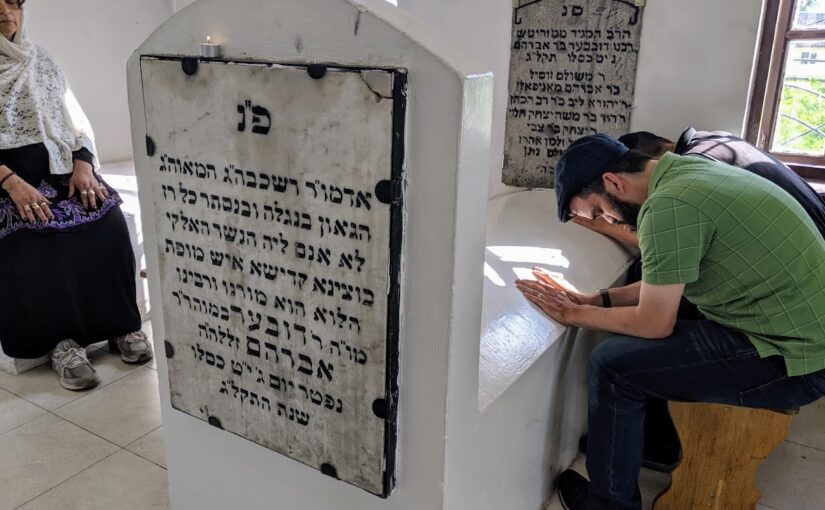 praying at hasidic grave