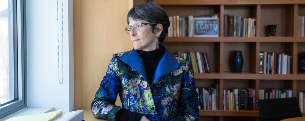 Rabbi Sharon Cohen Anisfeld looking out a window