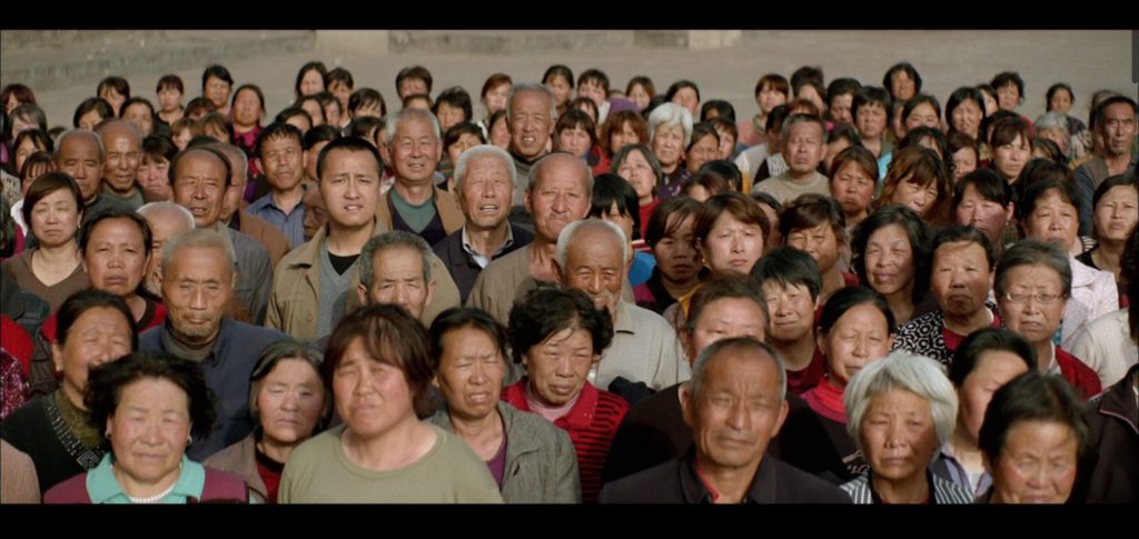 A crowd of people looking toward the camera.