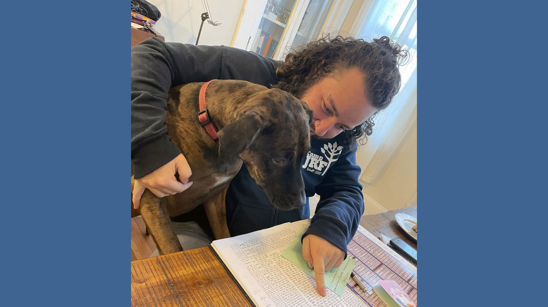 student reading text with dog