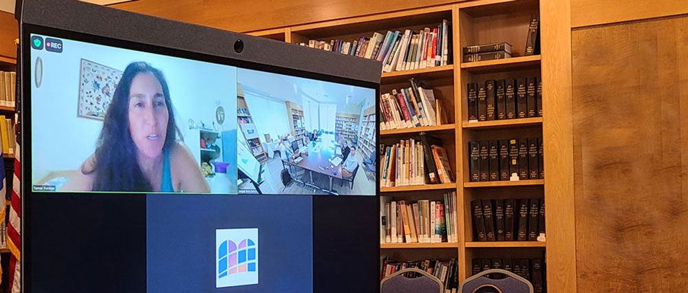 woman on screen talking to class