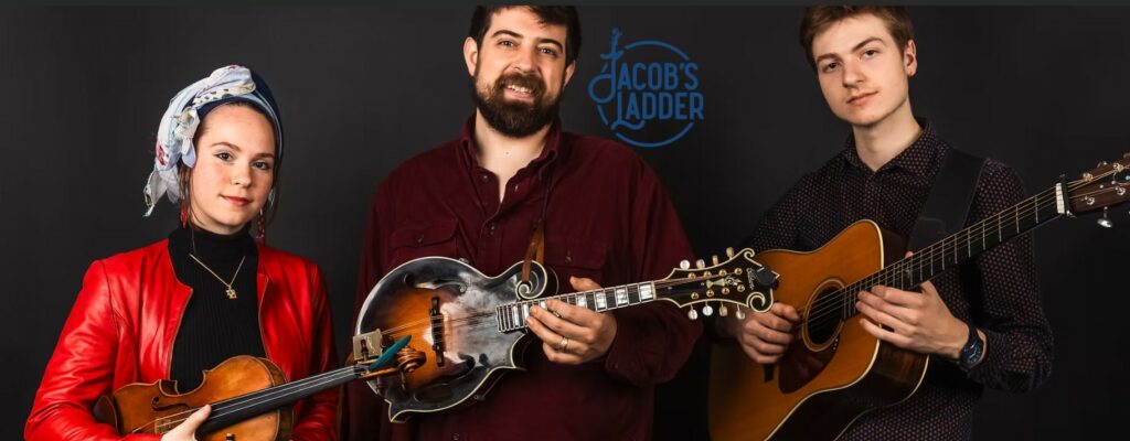 Group photo of three members of Jacob's Ladder music group, holding instruments